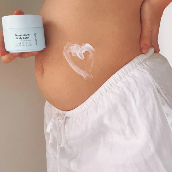 Pregnant women holding magnesium body balm